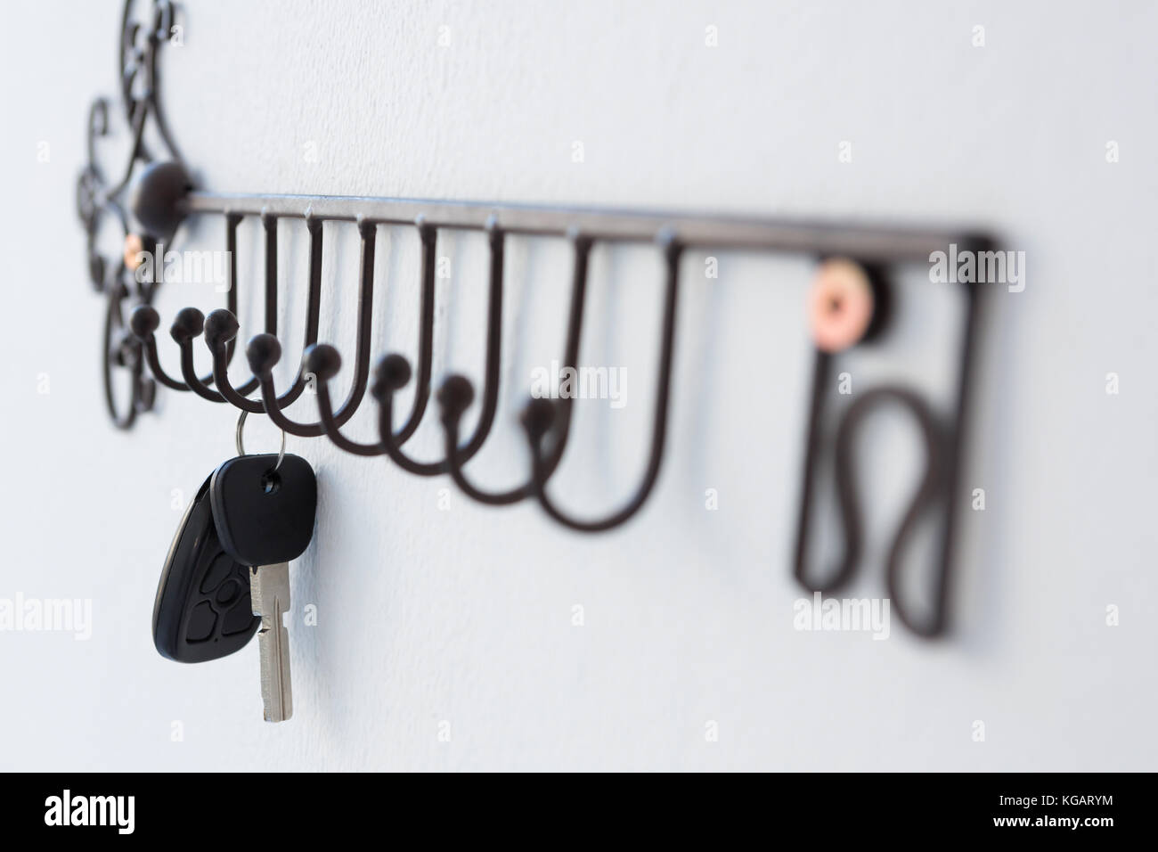 Closeup of keys hanging on hook against wall Stock Photo Alamy