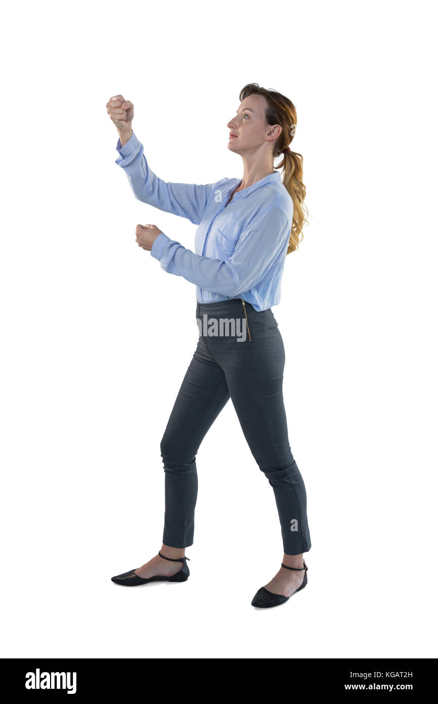 Female executive pretending to hold an invisible object against white background Stock Photo