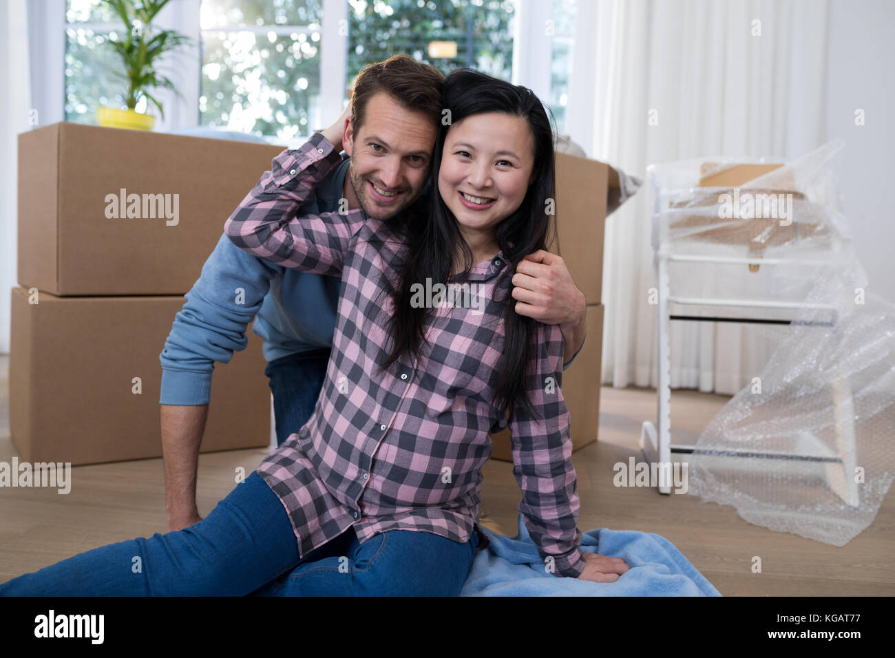 Happy couple relaxing at their new house Stock Photo - Alamy