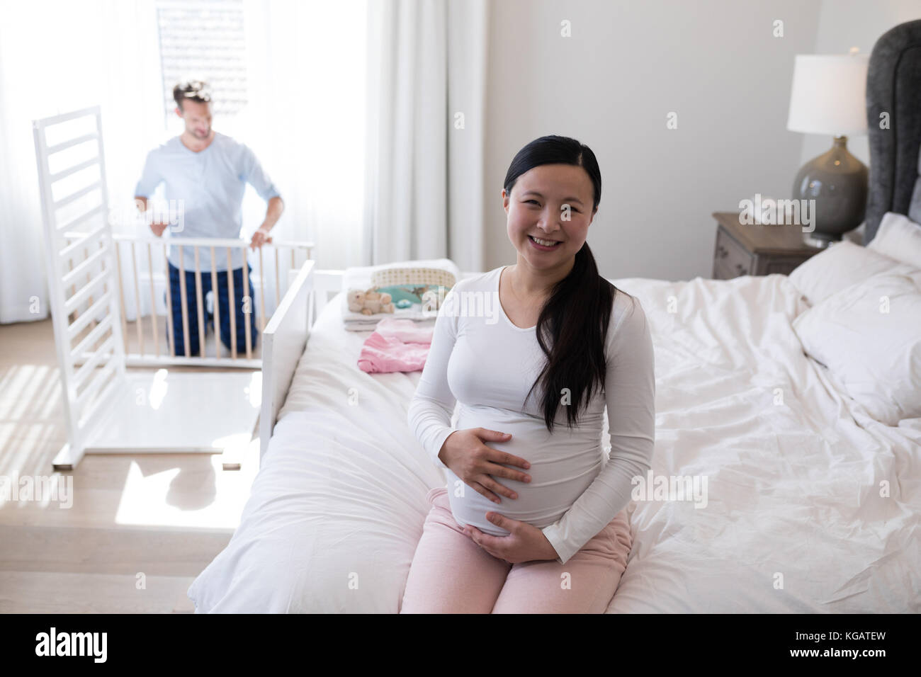 Portrait of happy woman feeling the presence of baby in stomach Stock Photo