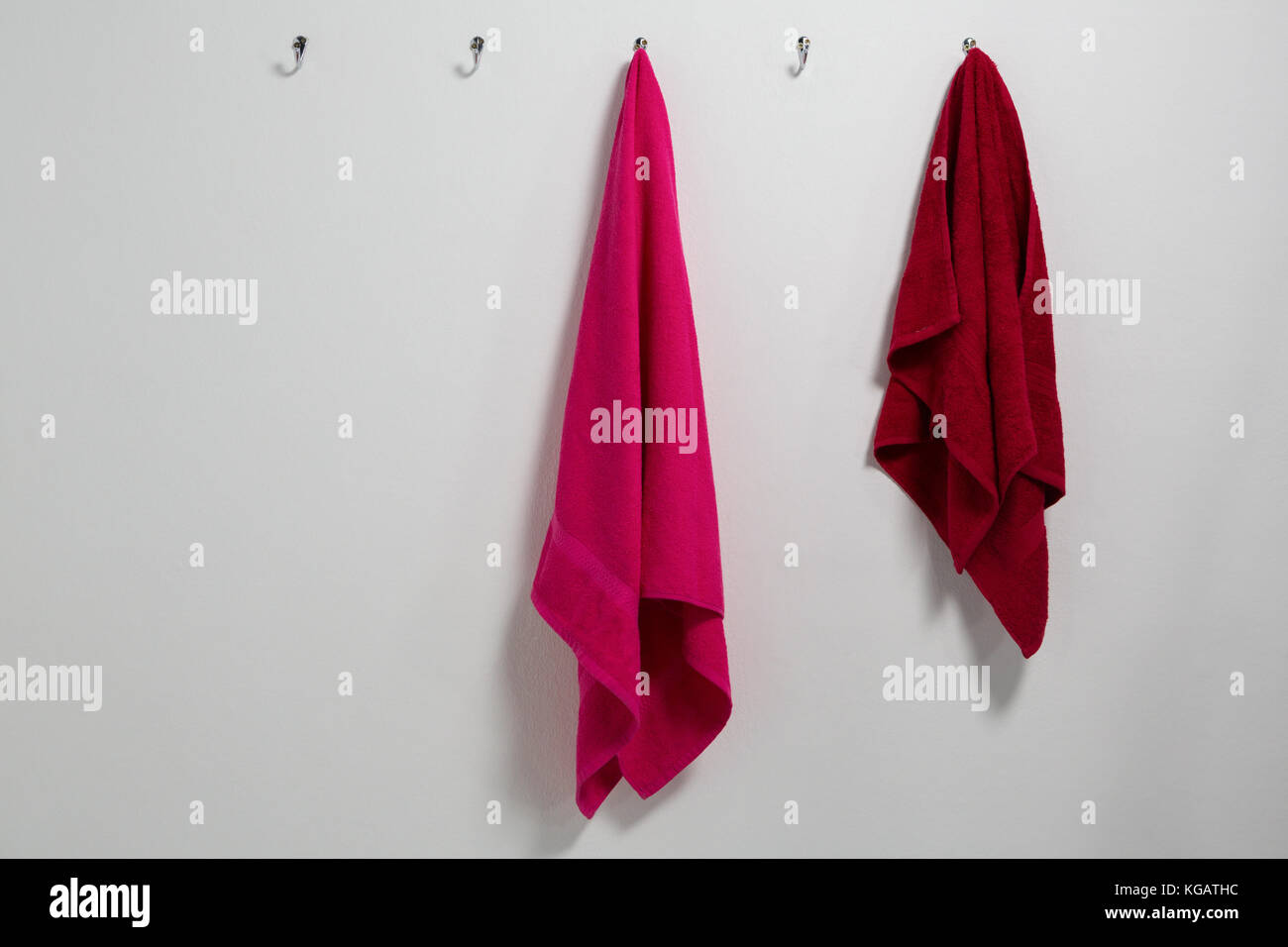 Towels hanging on hook against wall Stock Photo Alamy