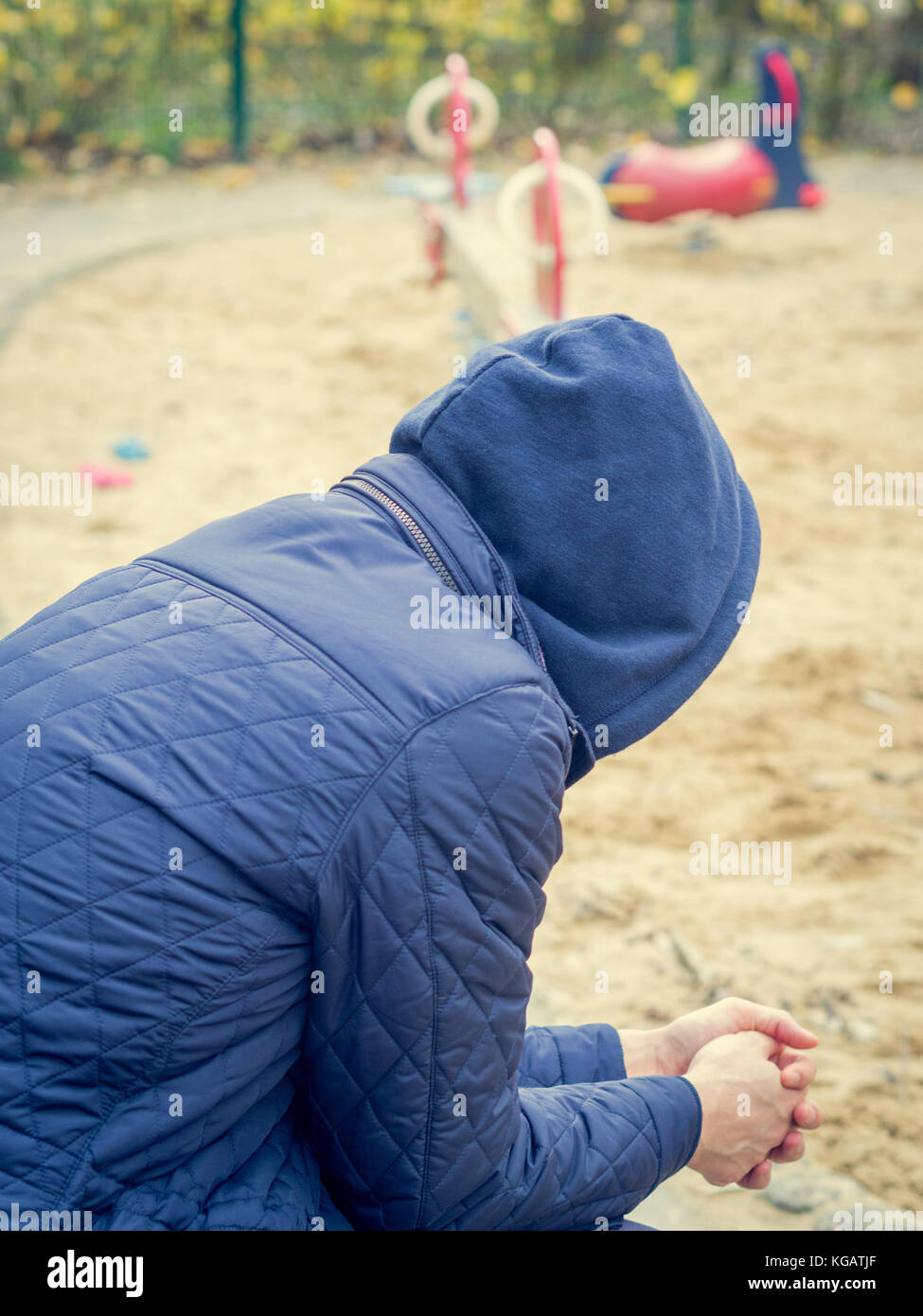Lonley man looking at a playground Stock Photo