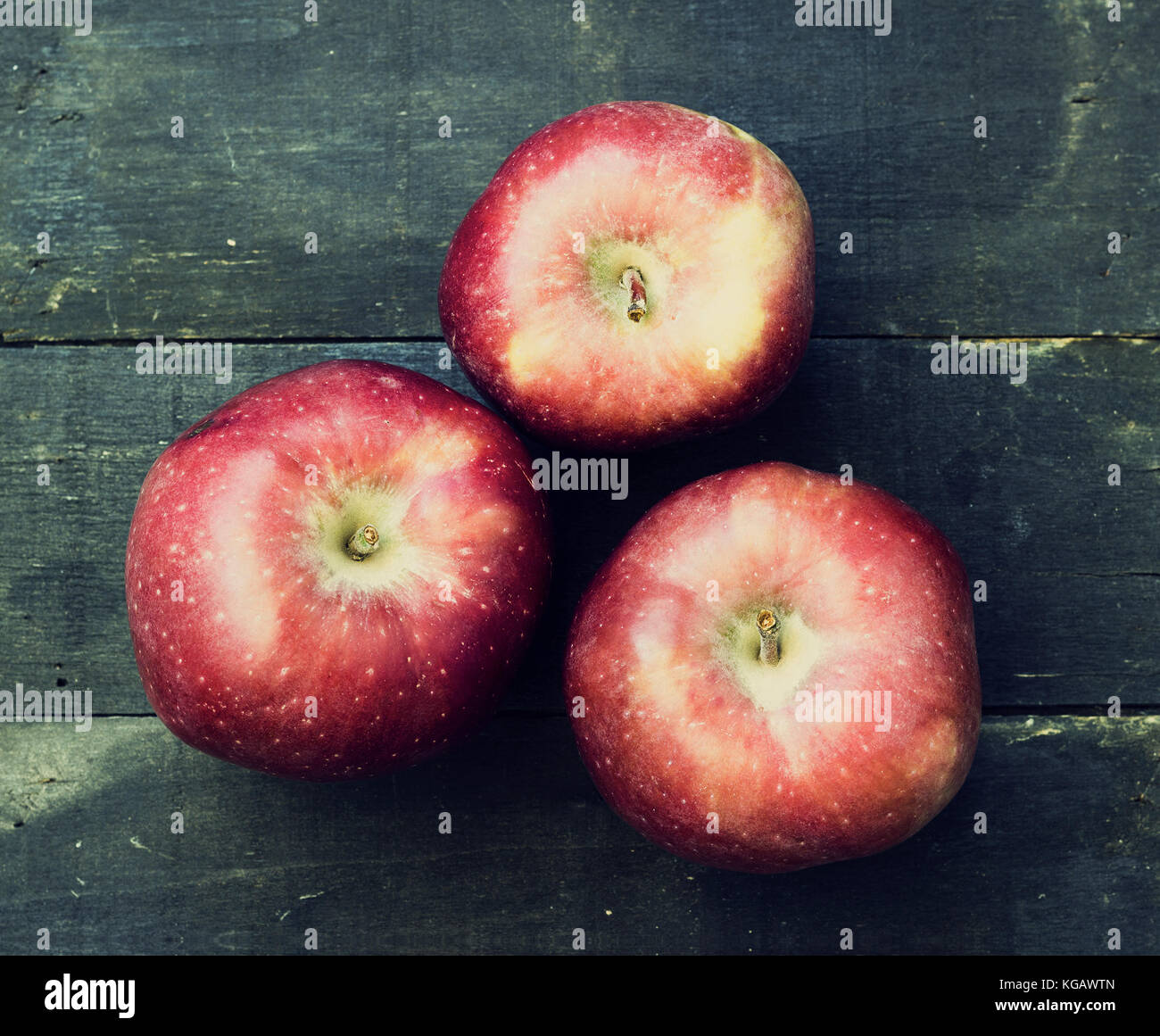 Red delicious apple on a wooden surface - vintage look Stock Photo