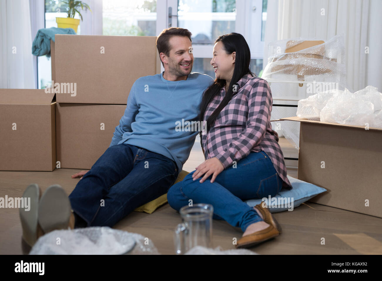 Happy couple relaxing together at their new home Stock Photo - Alamy