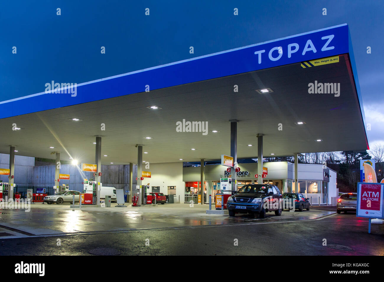 Garage filling station forecourt at dusk in Bantry, West Cork, Ireland with a blue sky. Stock Photo
