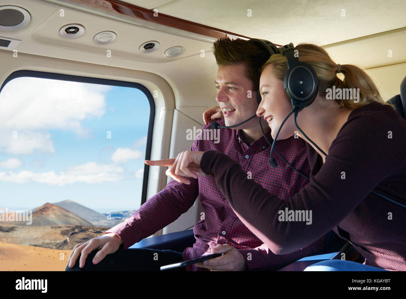 Couple On Vacation Taking Ride In Helicopter Stock Photo