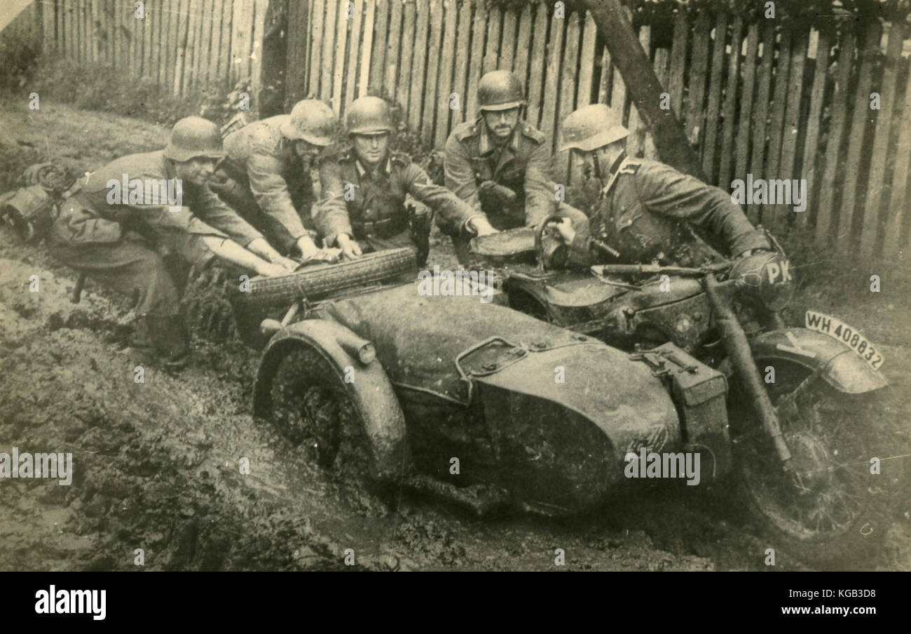 German soldiers of the II World War pushing a motorbike with sidecar Stock Photo