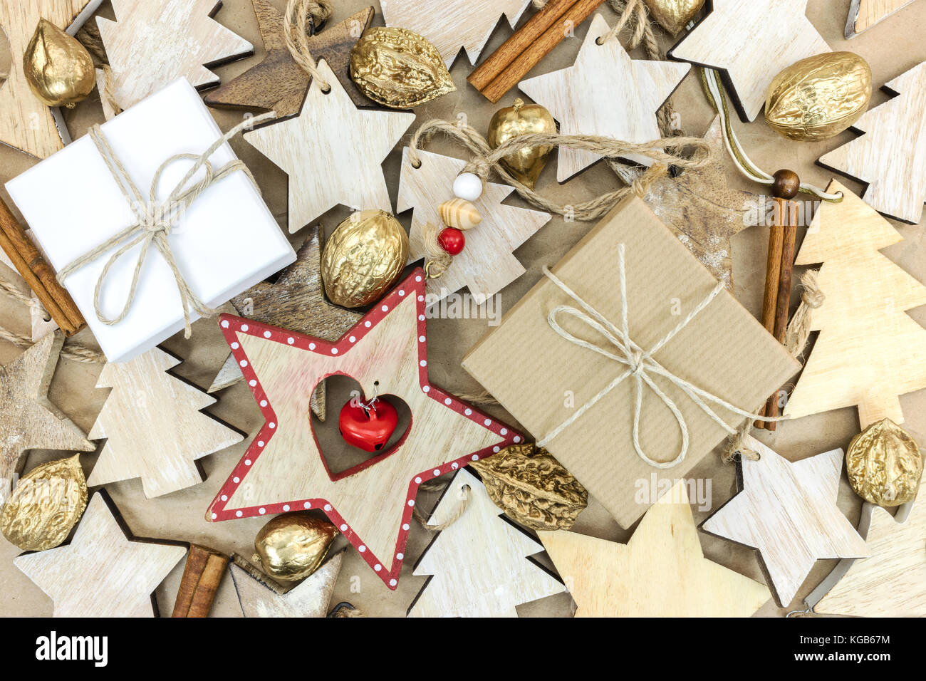 wooden christmas tree decorations, gift boxes, golden nuts on recycled