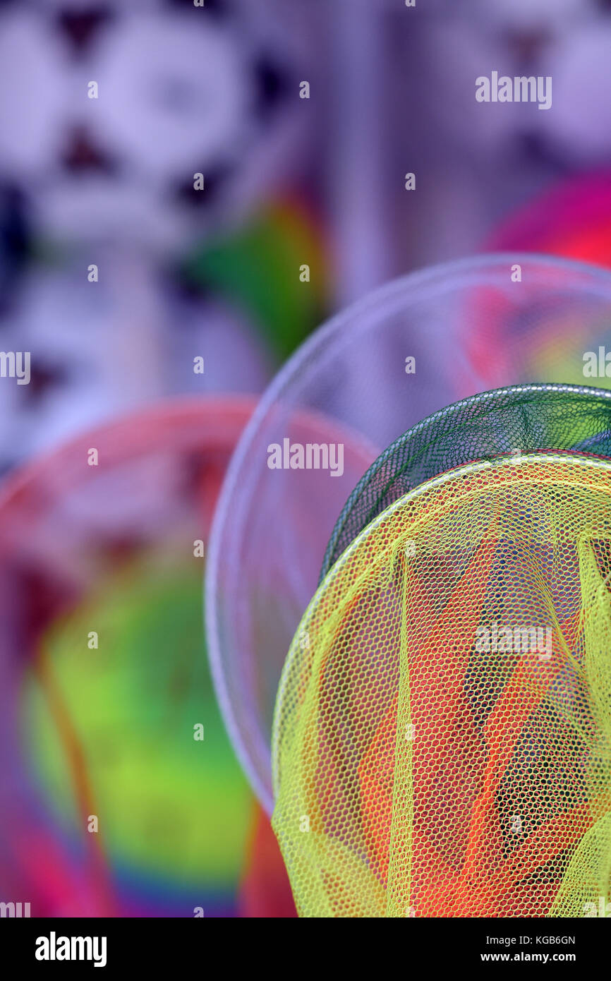colourful children;s fishing nets on display for sale at a beach shop