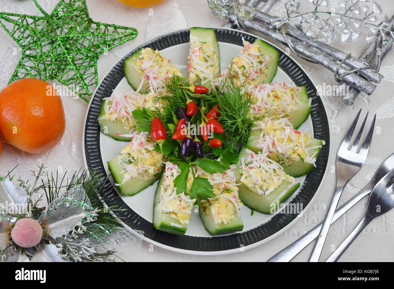 Appetizer from a fresh cucumber with crab meat, egg, cheese and dill
