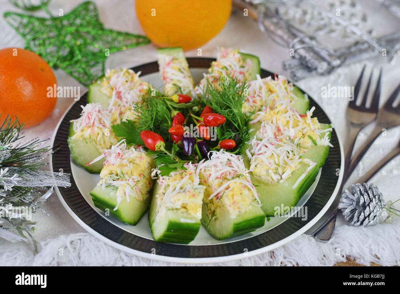 Appetizer from a fresh cucumber with crab meat, egg, cheese and dill