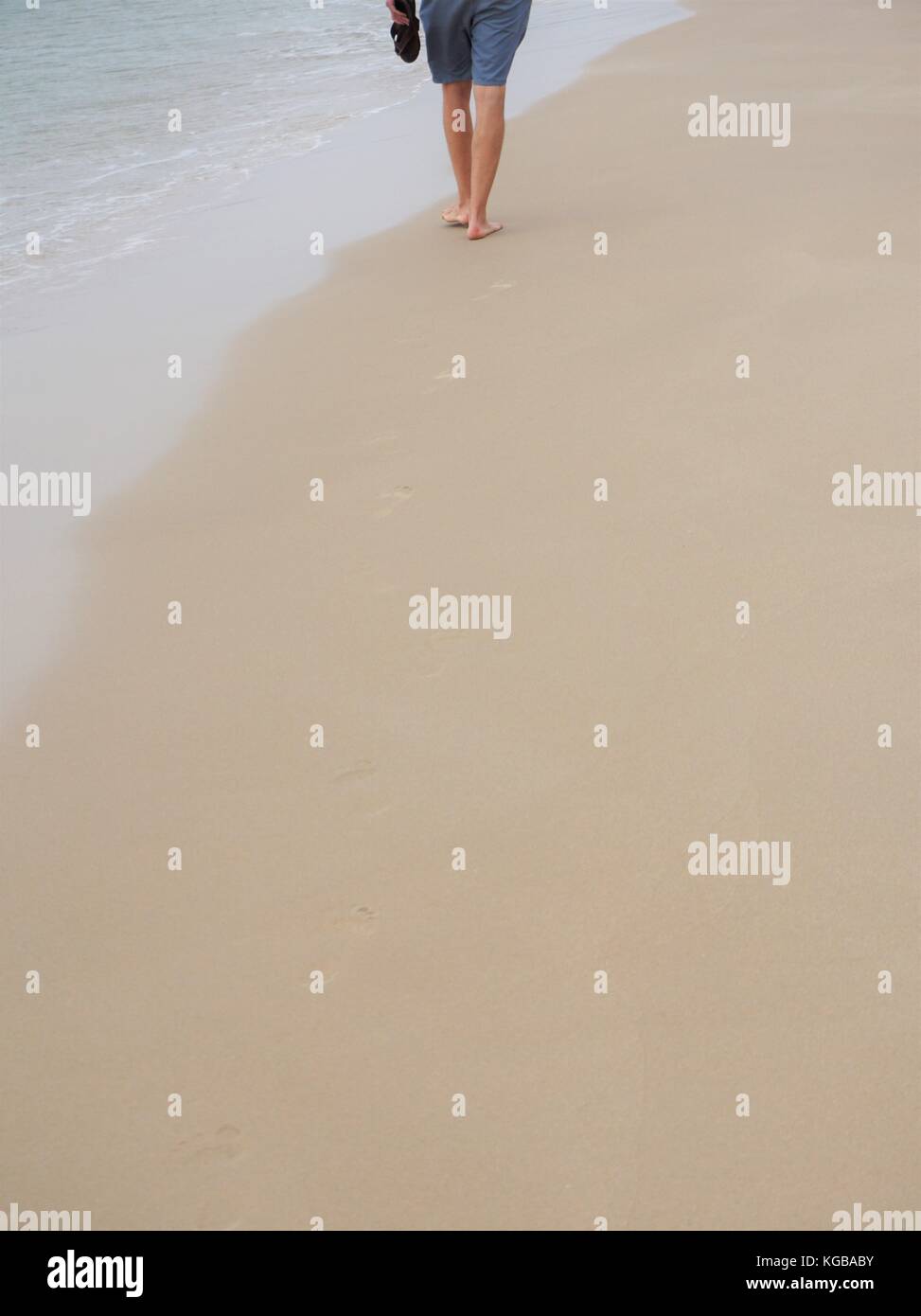 Lonely man walking on beach hi-res stock photography and images - Alamy