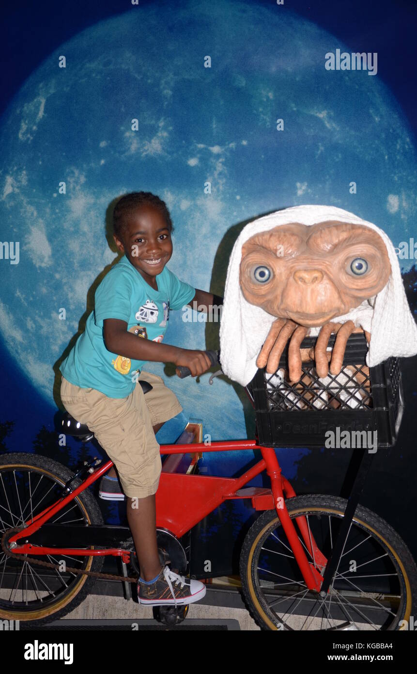 Young Afro-Caribbean boy riding bike with ET at Universal Studios Stock  Photo - Alamy