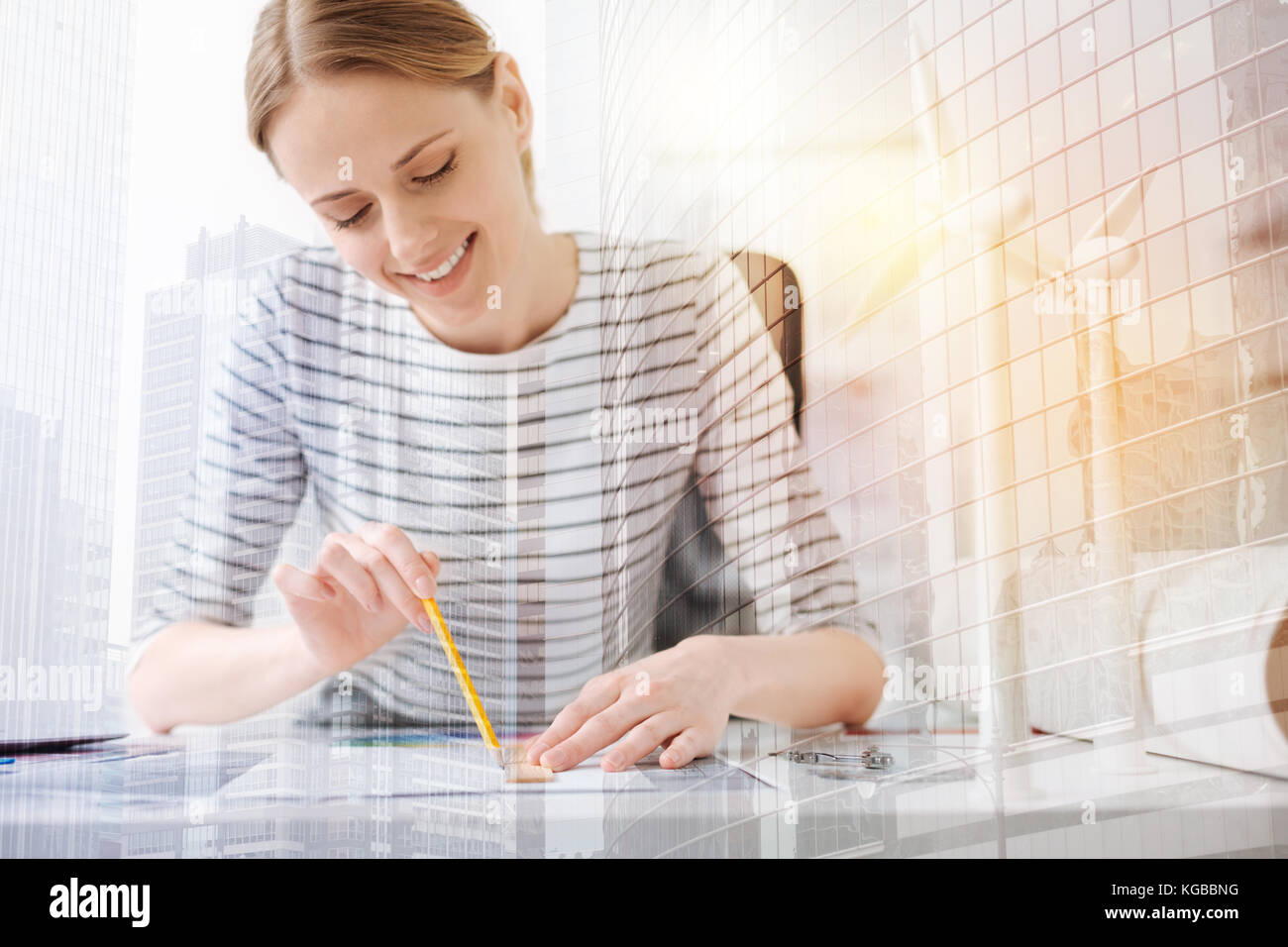 Cheerful woman engineer drawing a blueprint Stock Photo - Alamy