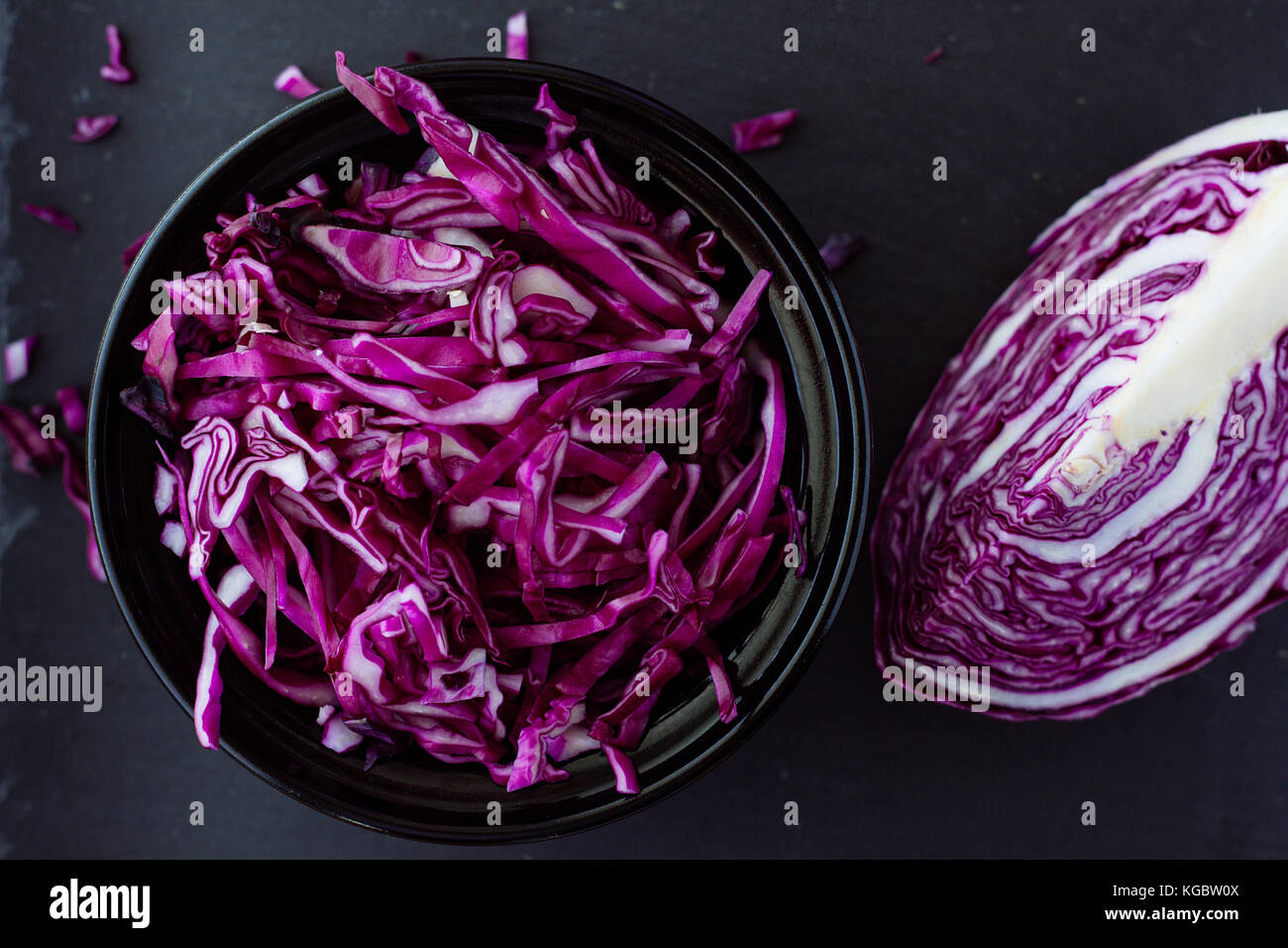Red cabbage salad in black bowl top view selective focus Stock Photo