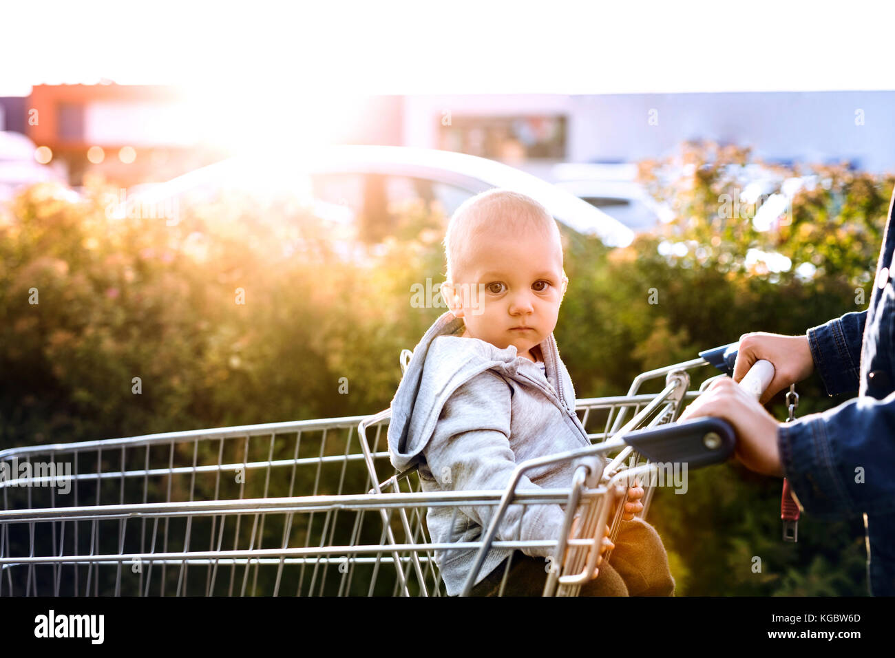 Mother with baby boy going shopping in the car park. Stock Photo