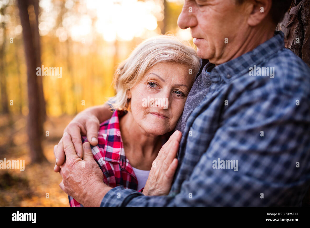 Senior couple on a walk in an autumn forest Stock Photo - Alamy