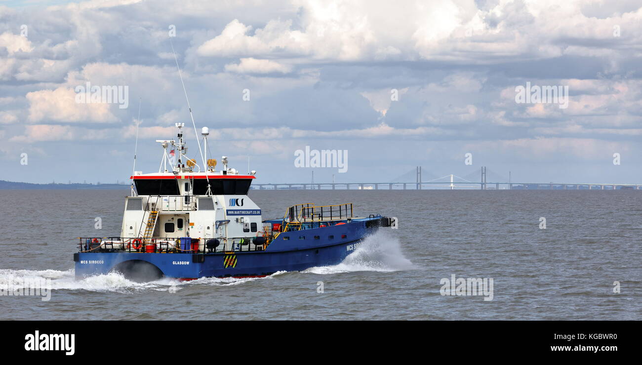 Twin hulled windfarm support vessel MCS Sirocco (Crew Boat) powering up the Bristol Channel to Avonmouth with the two Severn bridges backdrop Stock Photo