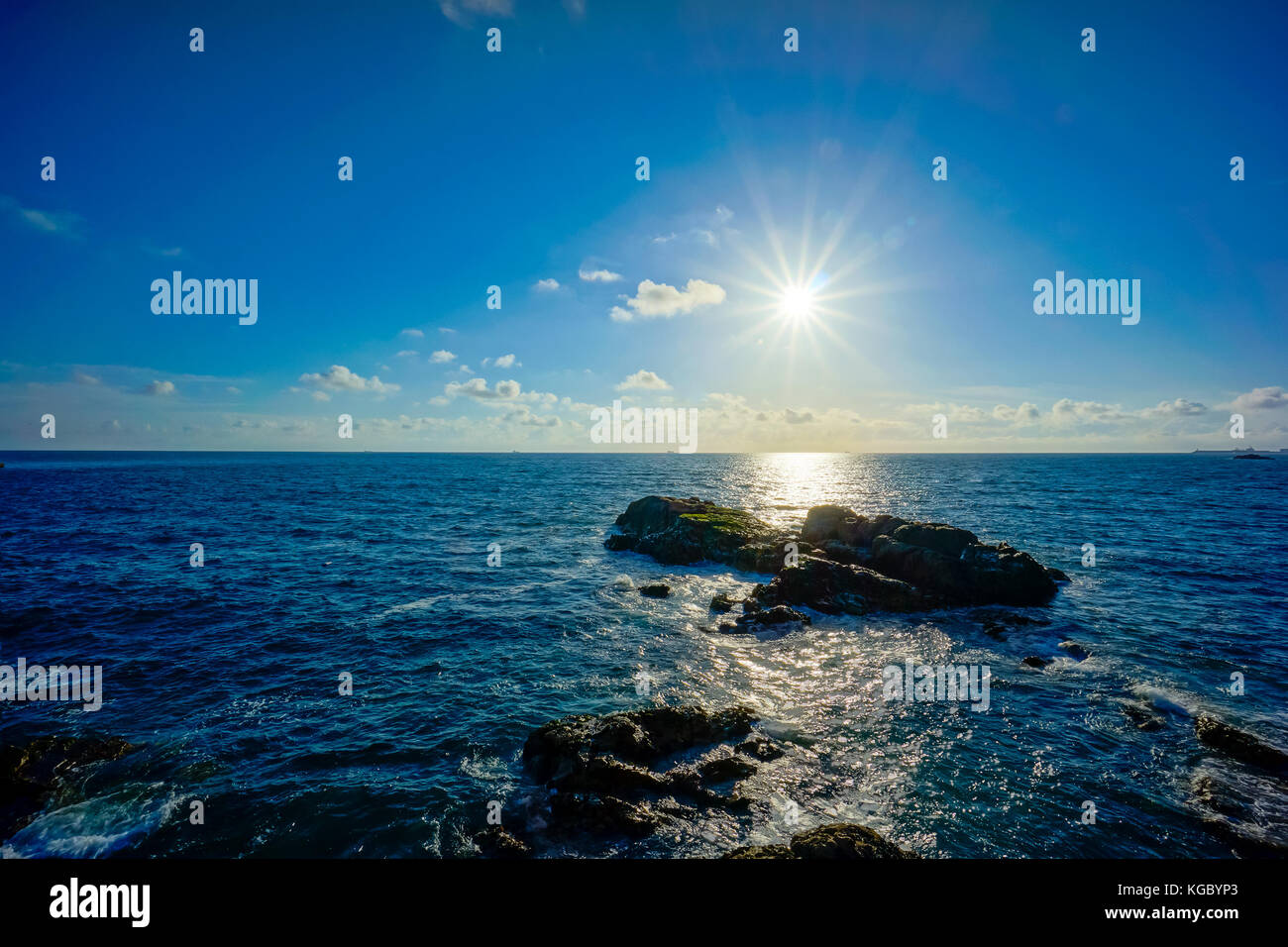 Sunset on rocky shore Stock Photo - Alamy