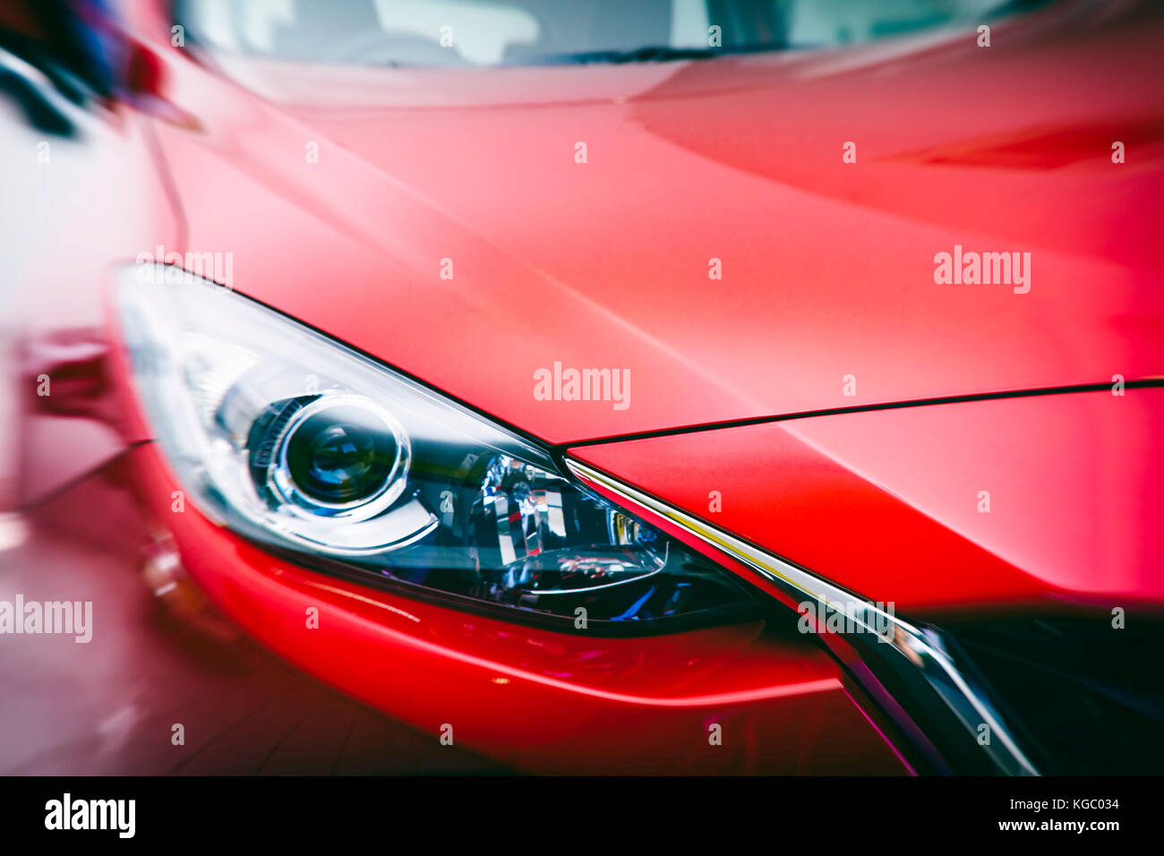 Modern car headlights and front hood, bumper and windscreen. Car