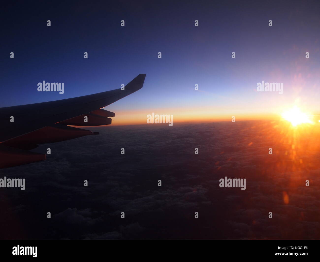 Plane wing at sunrise Stock Photo