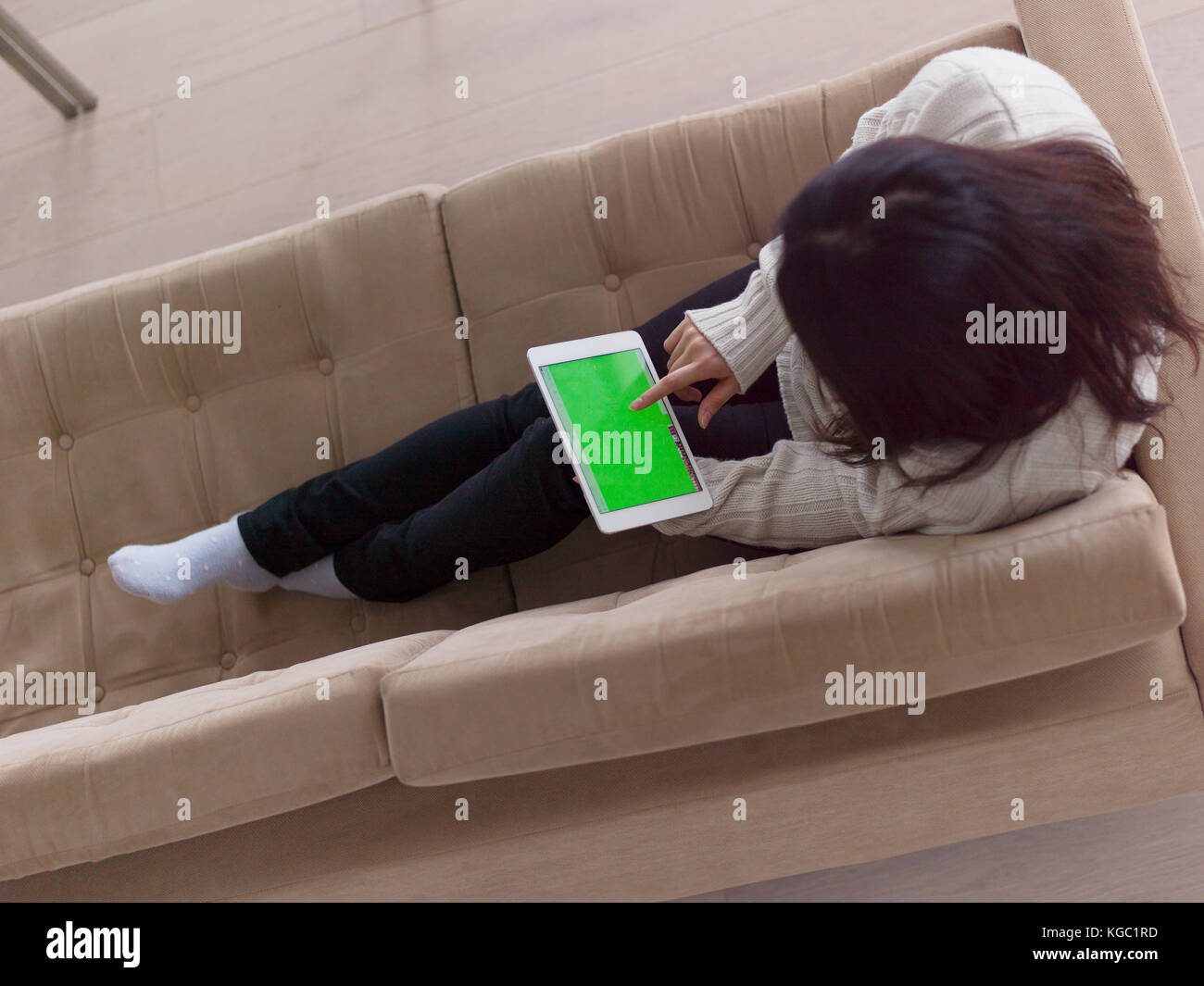 top view of young happy asian woman sitting on sofa using Digital ...