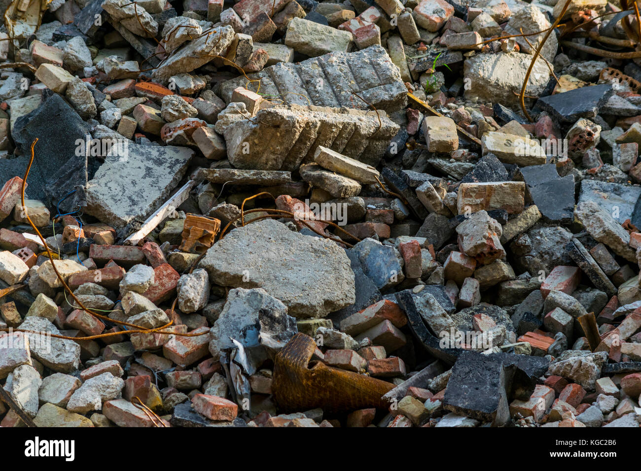 Pile of rubbish, demolished house, background. Stone, brick and metal debris waste, closeup. Stock Photo