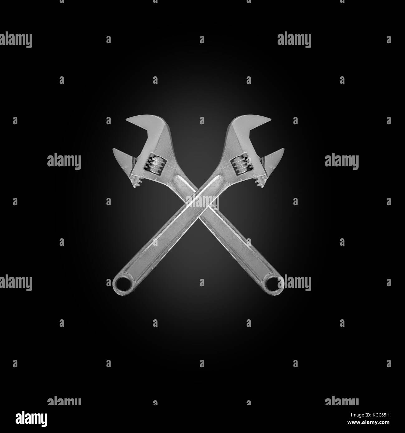 Tools - Two crossed adjustable spanner on a black background. Stock Photo