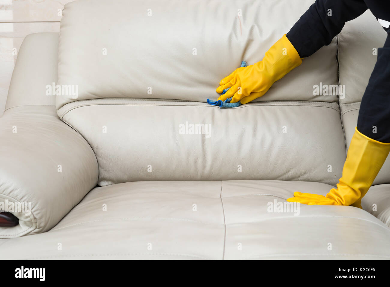 cleaning leather sofa at home Stock Photo - Alamy