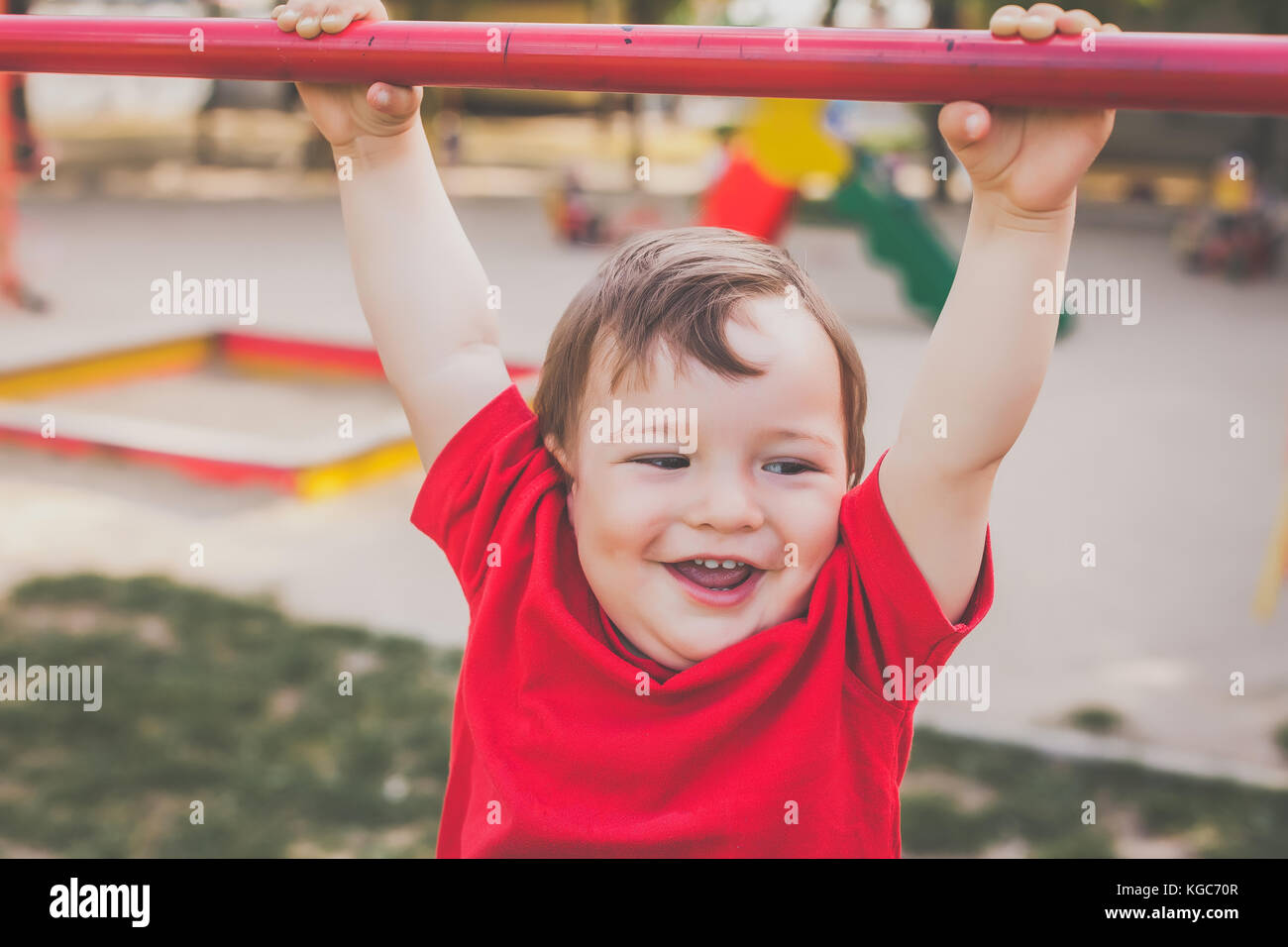 cute boy smiling and playing on playground Stock Photo - Alamy