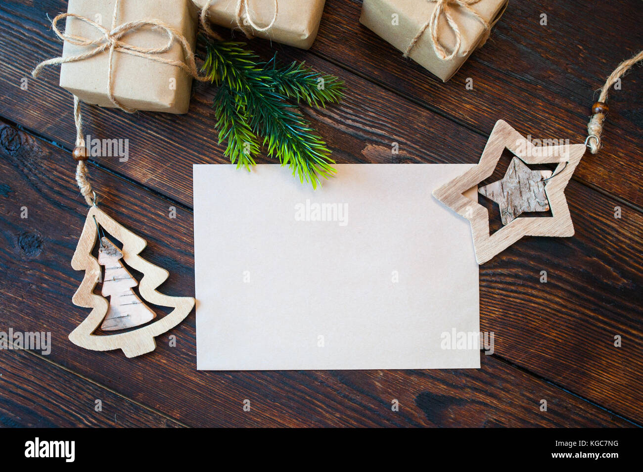Stylish branding mockup to display your artworks. Cute vintage christmas new year gifts, star, tree mock up on wooden background Stock Photo