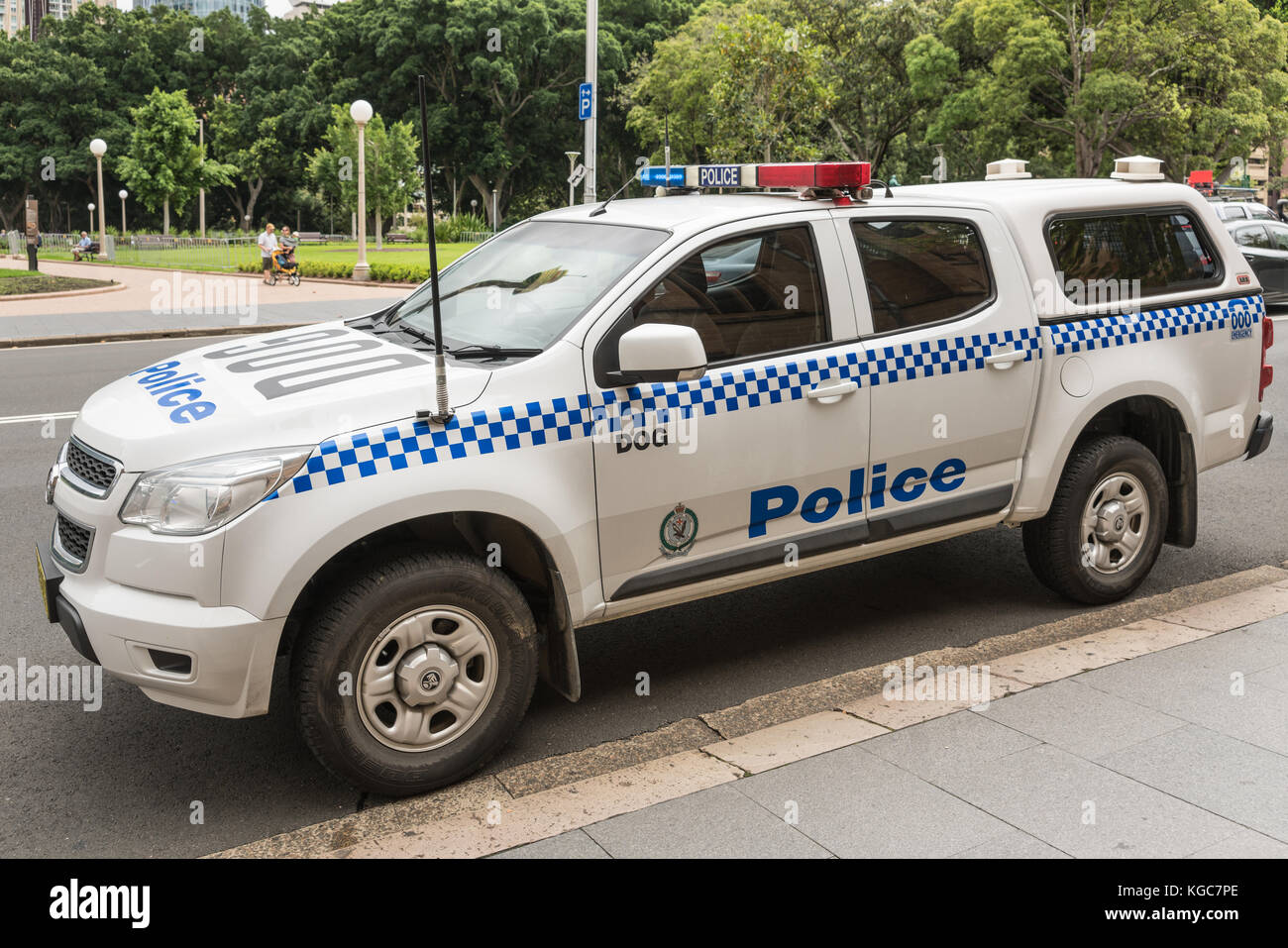 Sydney, Australia - March 23, 2017: Closeup of white and blue police SUV car of canine unit parked on side of Saint Marys Cathedral. Park in backgroun Stock Photo