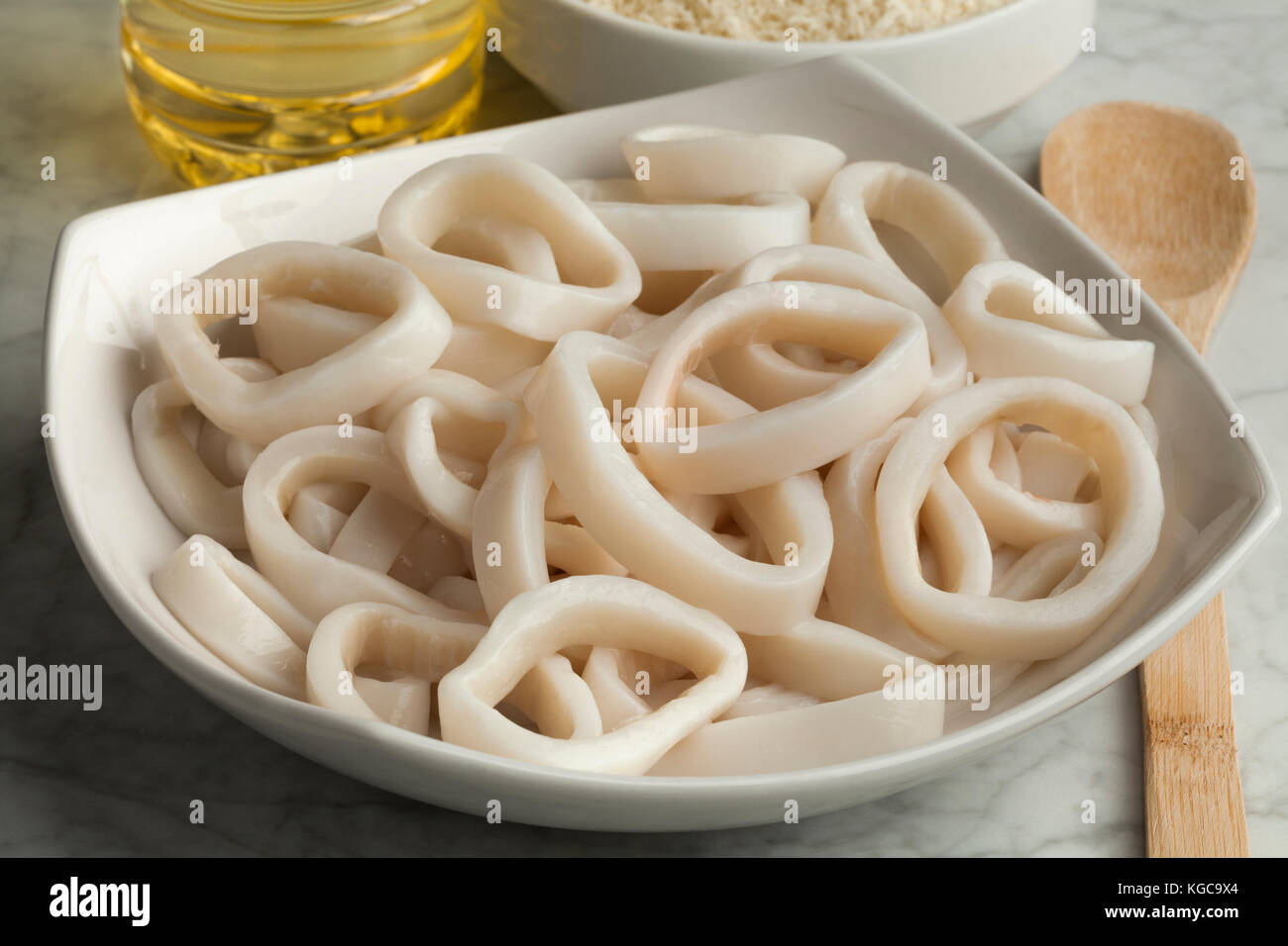 Heap of fresh raw squid rings on a dish Stock Photo