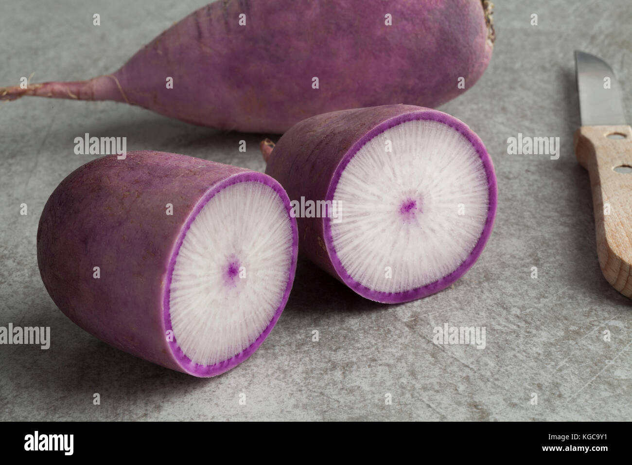 Fresh whole and half purple Japanese daikon radish Stock Photo