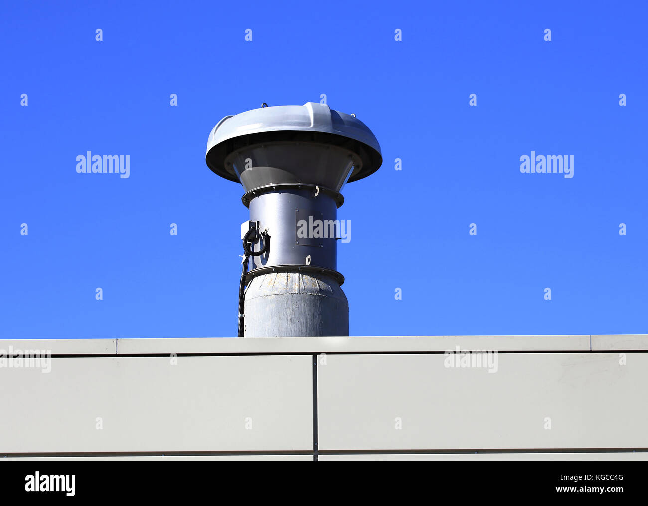 Ventilation pipe on the roof of an industrial building Stock Photo