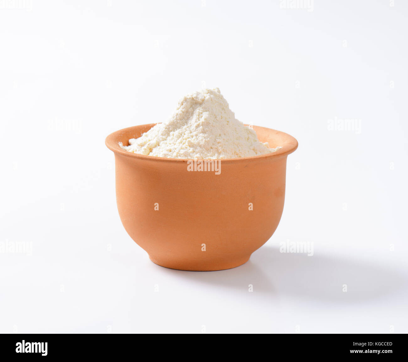 Finely ground flour in terracotta bowl Stock Photo