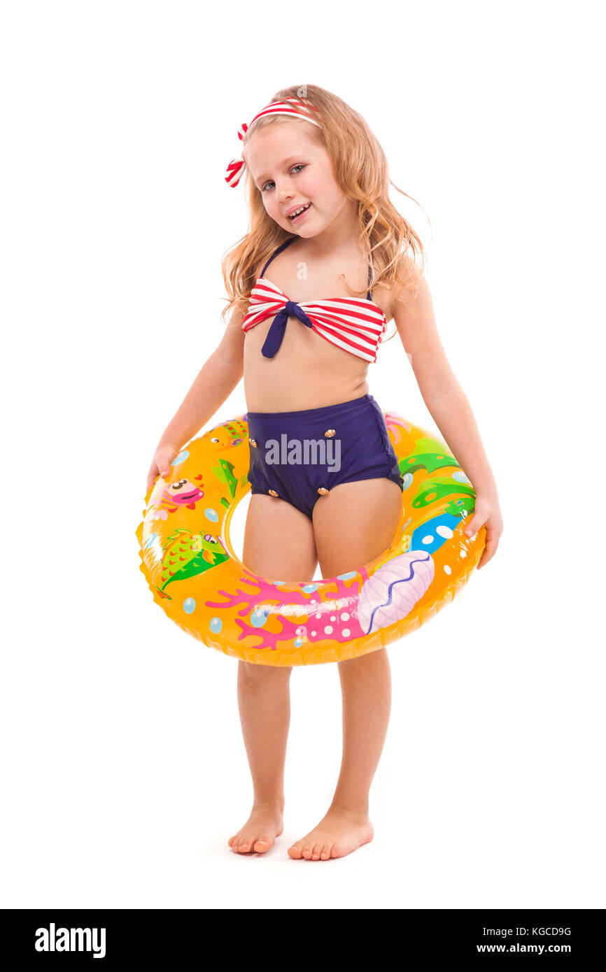 Beautiful little girl in red striped bikini, blue bottoms and pink wreath  stand stand with colorful rubber ring on the waist Stock Photo - Alamy