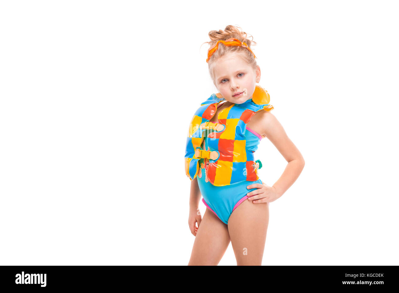 Beautiful little girl in in blue swimming suit and colorful life jacket