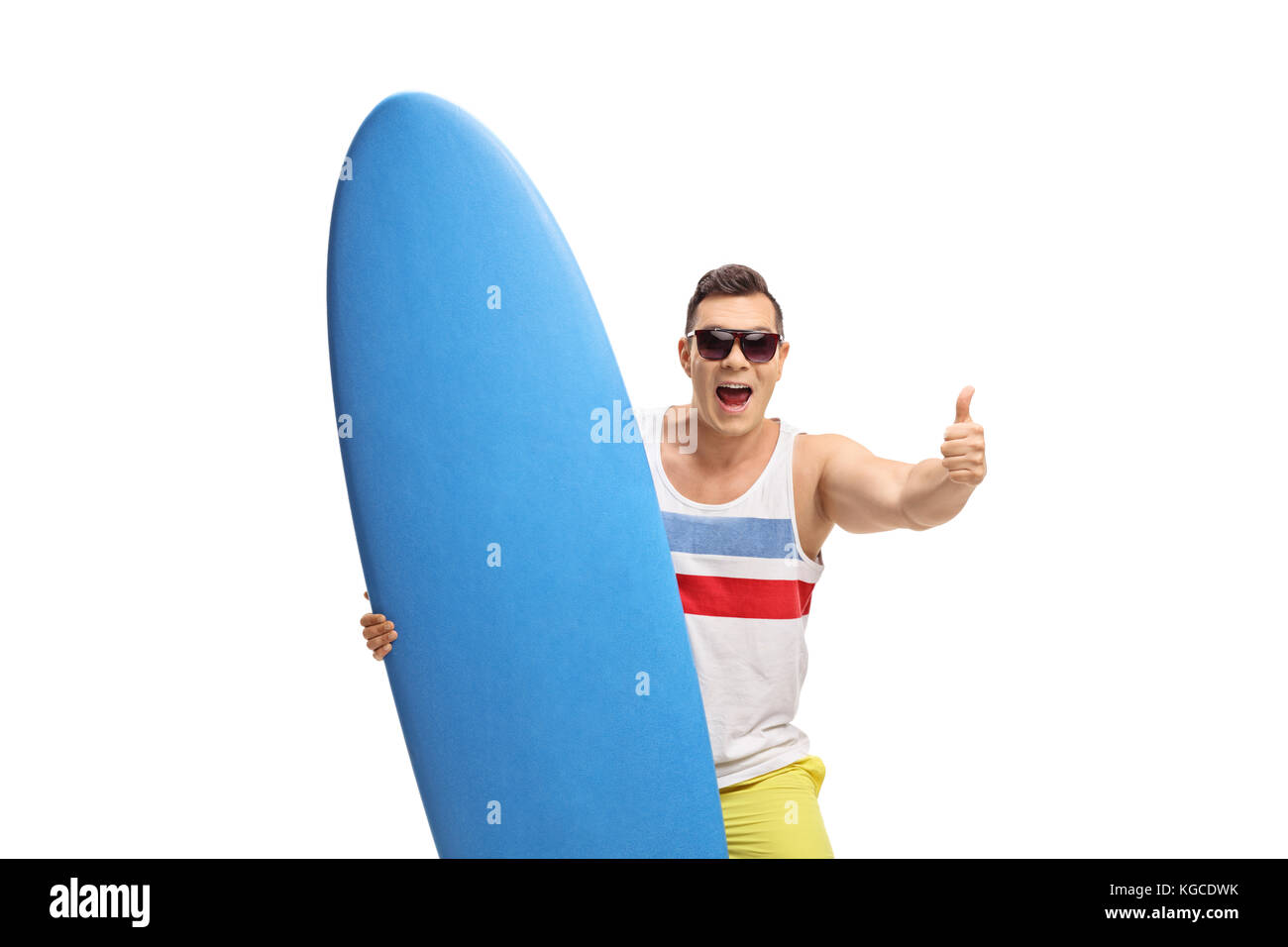 Joyful surfer with a surfboard making a thumb up sign isolated on white ...