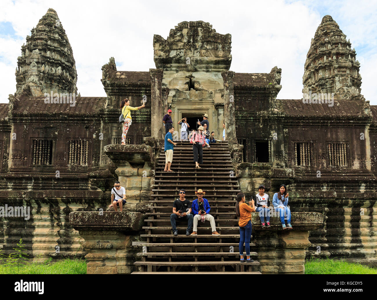 Tourists Sitting and Having Fun at Angkor Wat Temple of Cambodia. Stock Photo