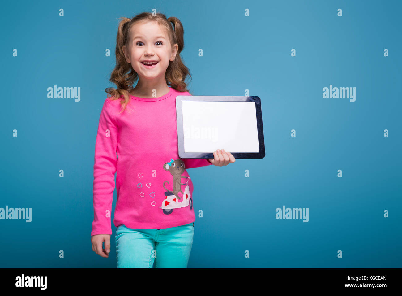 Attractive Little Cute Girl in Pink Shirt with Monkey and Blue Trousers  Talks a Phone Stock Photo - Image of portrait, holding: 103330114