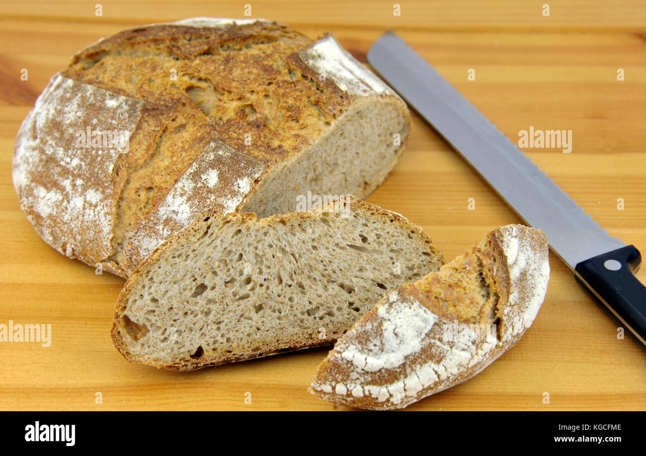 Crusty homemade artisan round wholemeal or whole wheat sourdough bread ...
