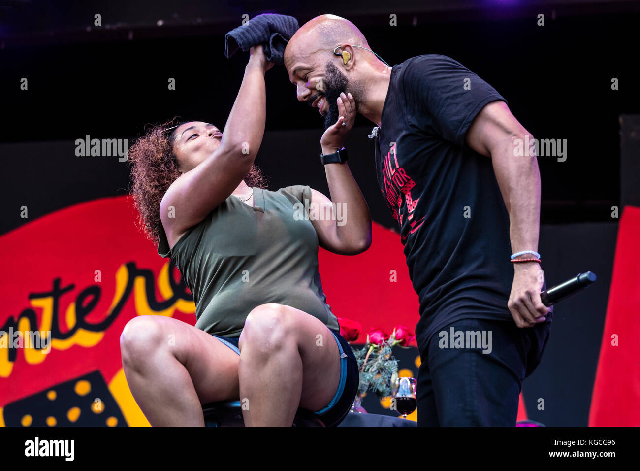Hip hop artist COMMON honors women by singing to a fan brought up on stage - 60th MONTEREY JAZZ FESTIVAL, CALIFORNIA Stock Photo