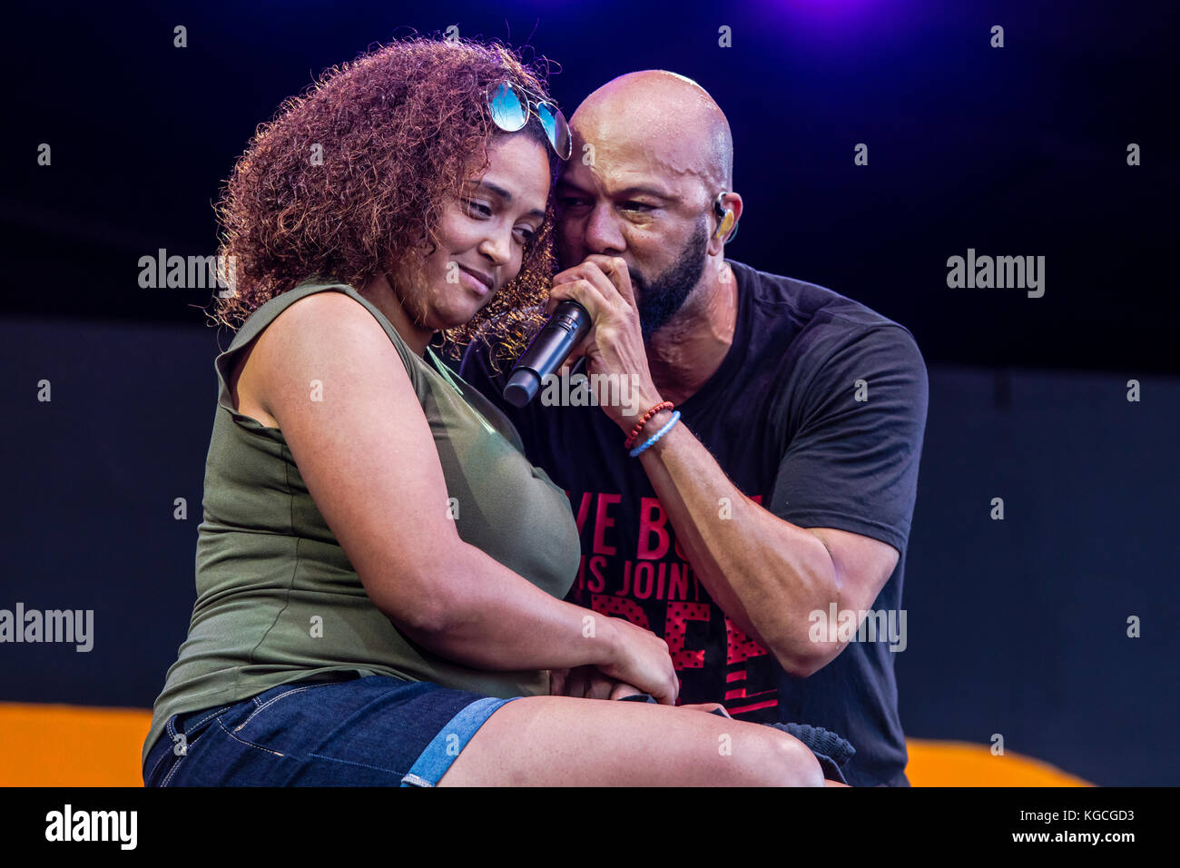 Hip hop artist COMMON honors women by singing to a fan brought up on stage - 60th MONTEREY JAZZ FESTIVAL, CALIFORNIA Stock Photo