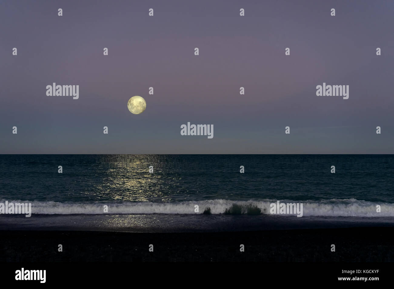 The Full Moon above the Ocean Surface Stock Photo