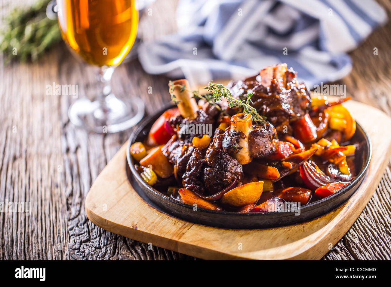Lamb shank.Confit lamb shank with potatoes vegetable and draft beer in pub hotel or restaurant. Stock Photo