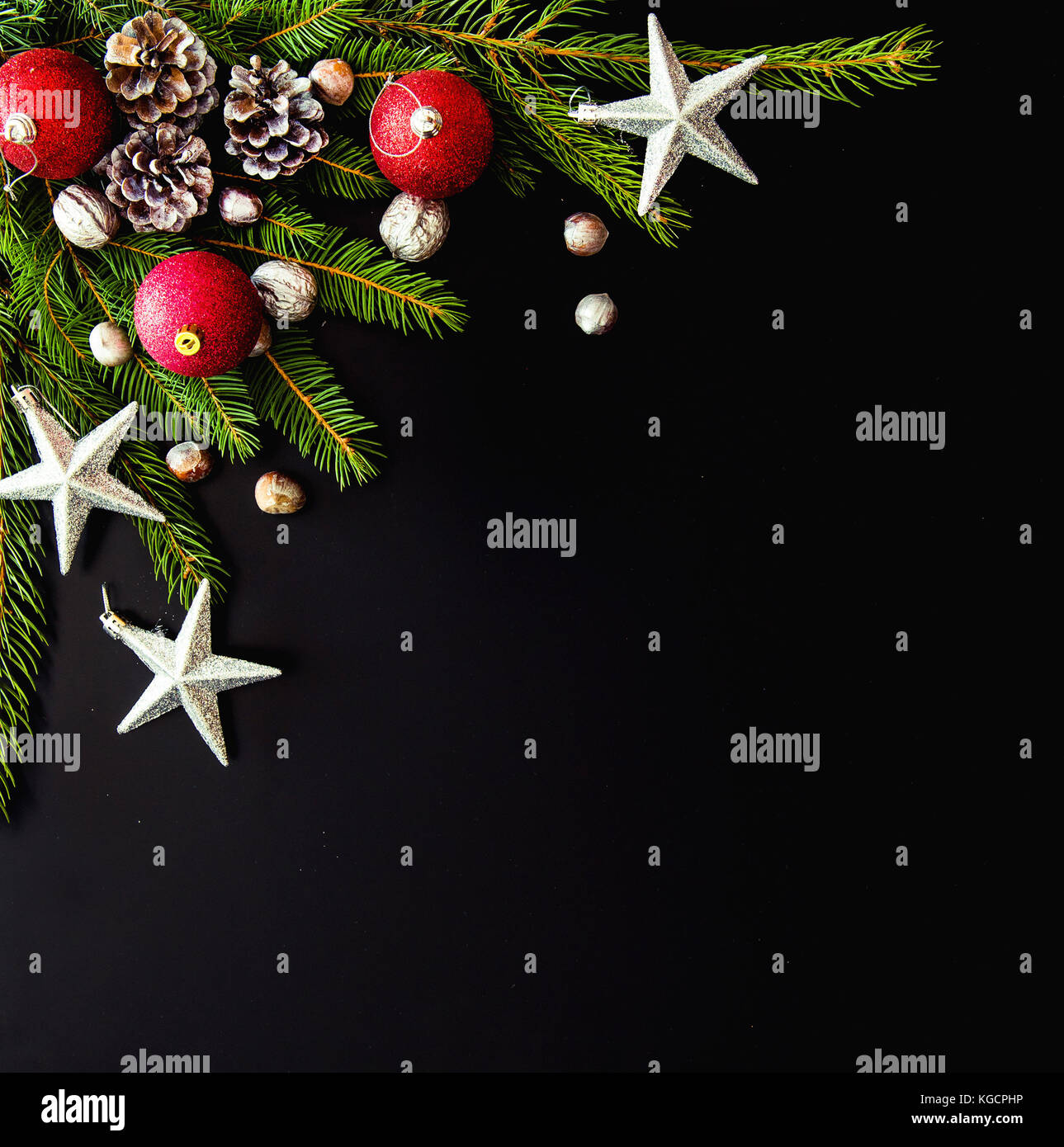 Christmas background with balls, stars, fir tree branches on black ...