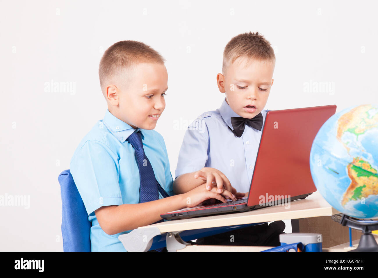 two boys sit at the computer training school Stock Photo - Alamy