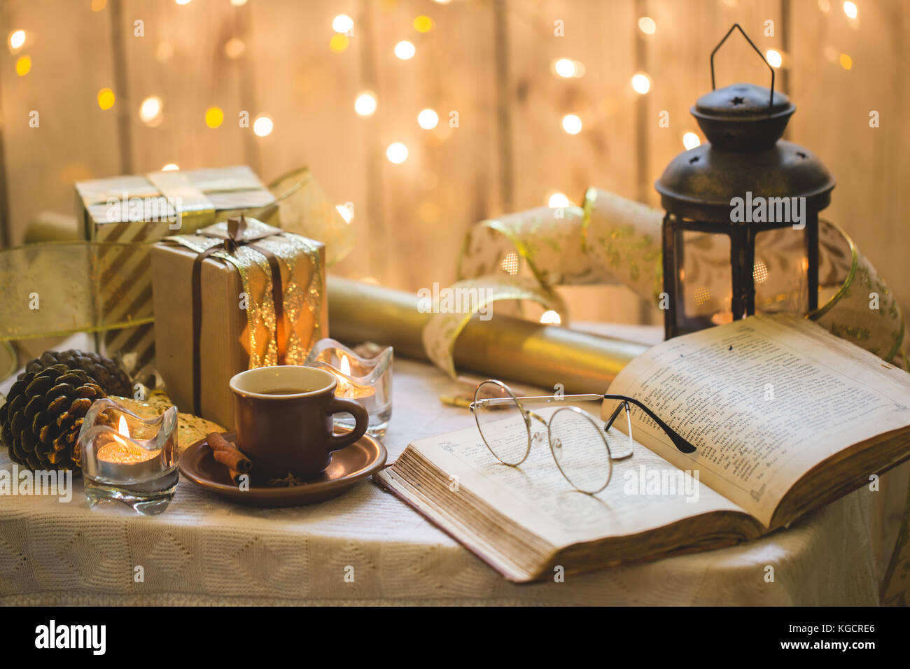 Christmas decoration. Old book with eyeglasses, cup of coffee Stock Photo