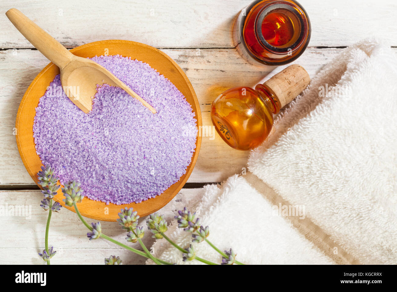 Wooden bowl of lavender bath salt with flowers, towels, apothecary bottle, birds view Stock Photo